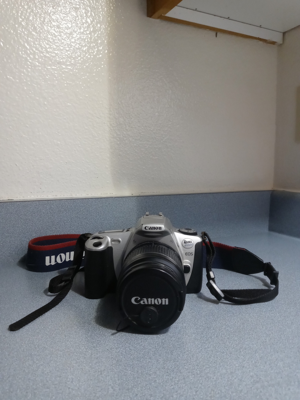 Canon DSLR Camera in Silver and Black with Red-Trim Strap